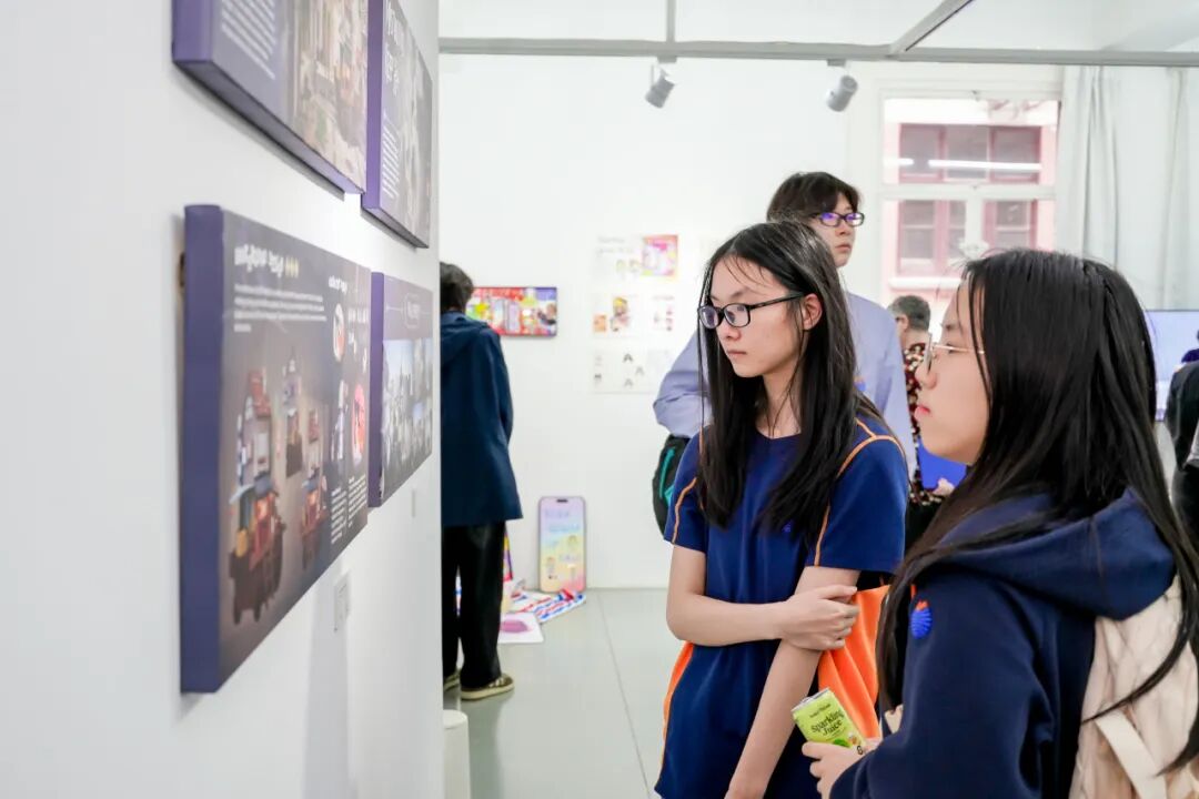 观众驻足欣赏校友参展作品